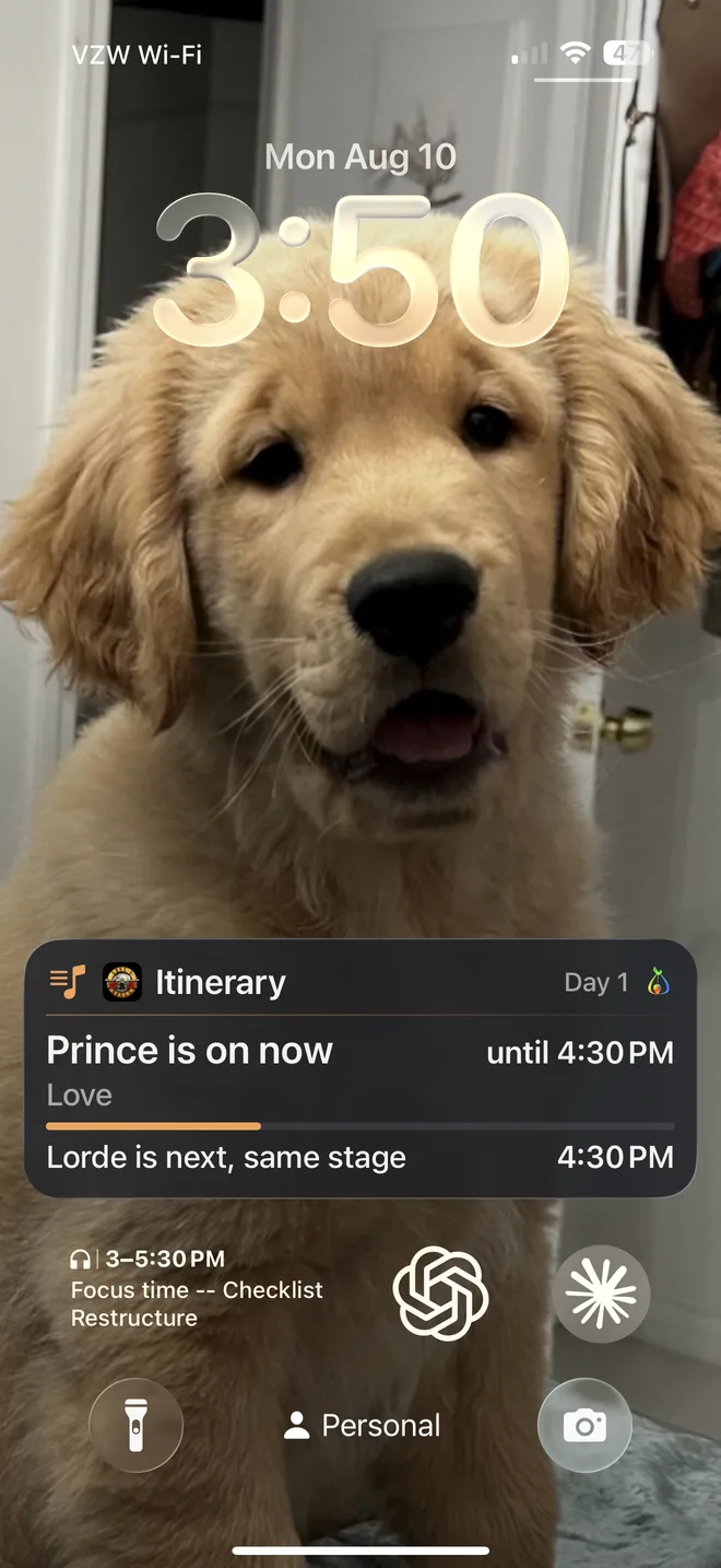 A real lock screen with the FindTribe itinerary Live Activity — “Your Itinerary, Day 1: Prince is on now until 4:30 PM; Lorde is next, same stage”