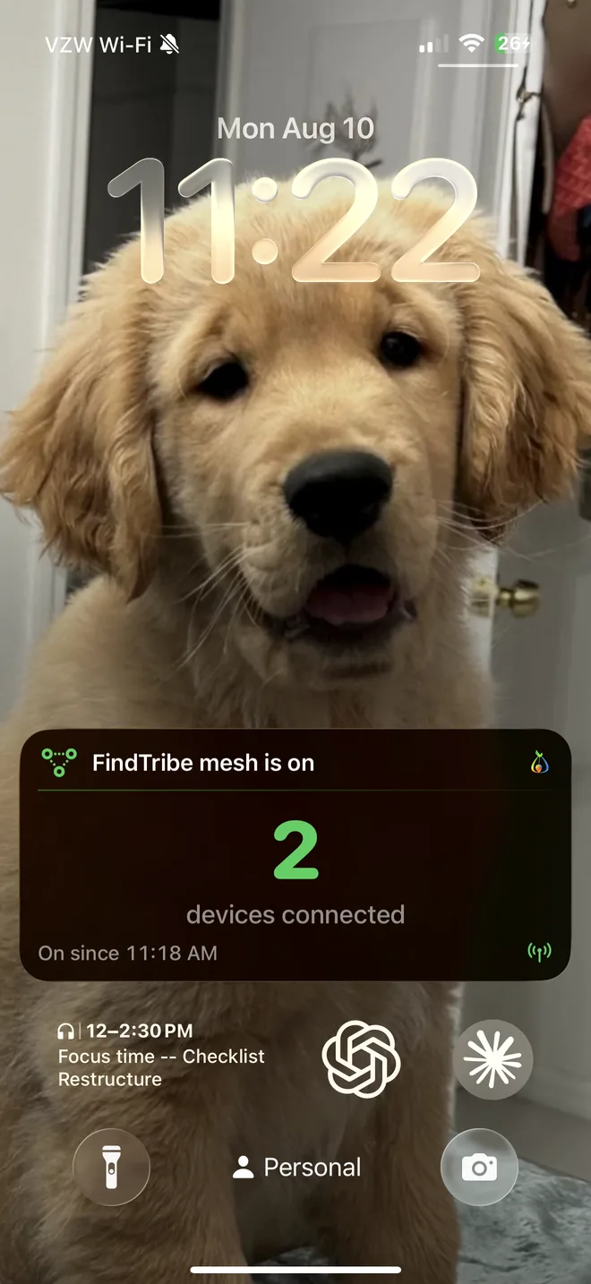A real lock screen with the FindTribe mesh Live Activity — “FindTribe mesh is on, 2 devices connected, on since 11:18 AM”